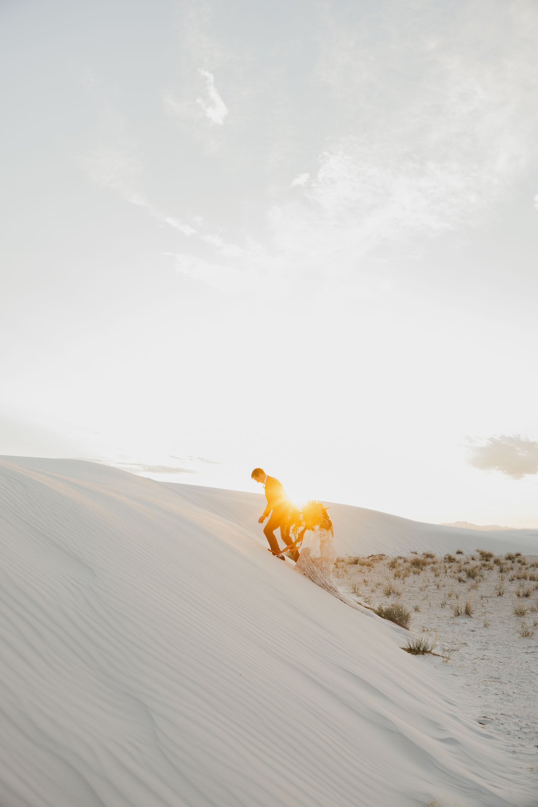 stunning bride and groom pose together with the dunes in background after their dreamy White Sands elopement day