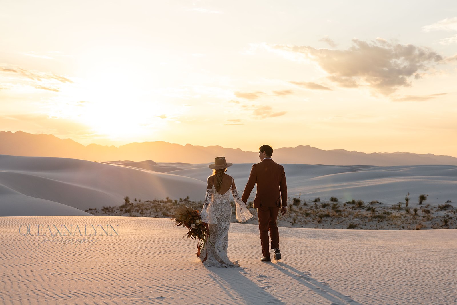 stunning bride and groom pose together with the dunes in background after their dreamy White Sands elopement day