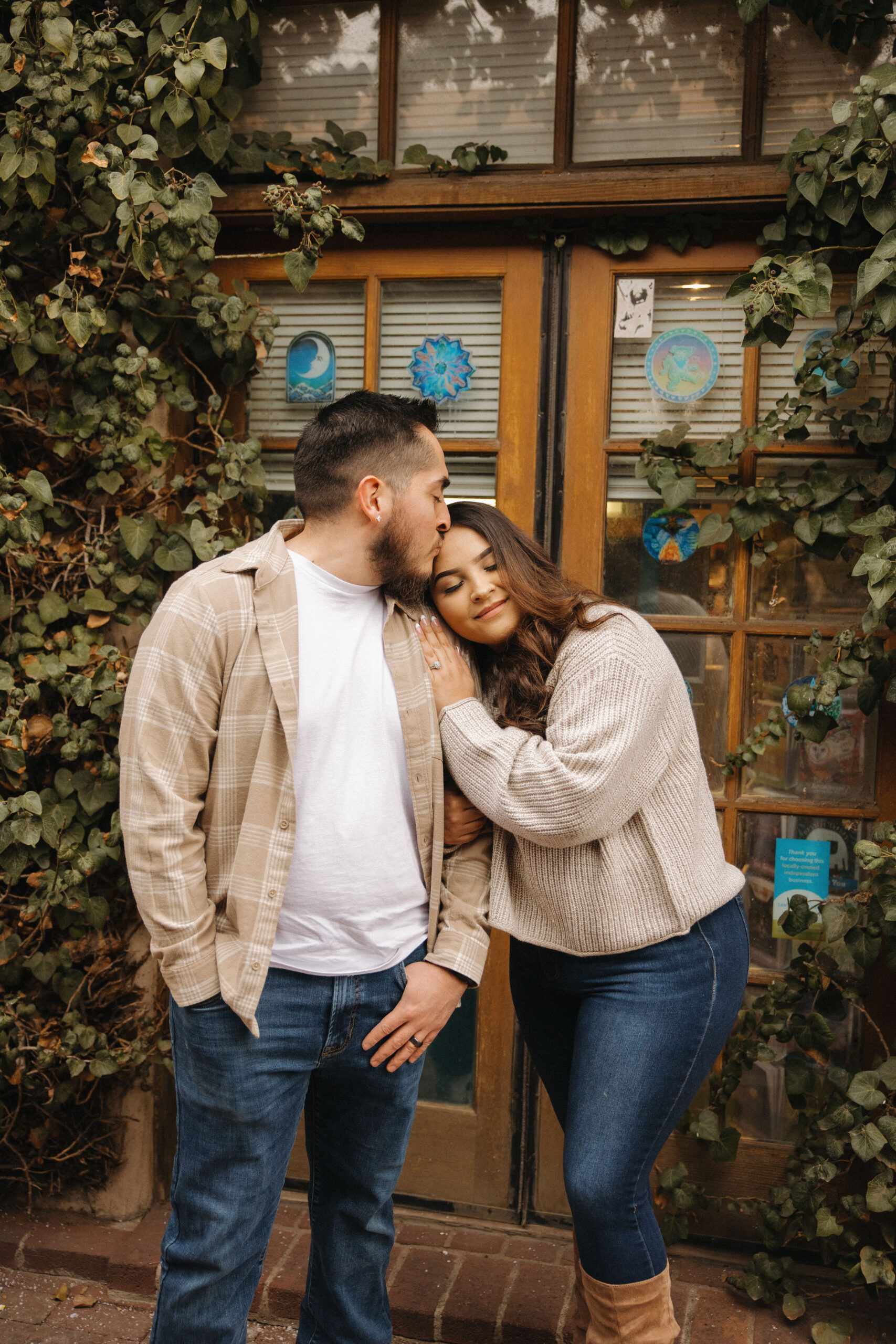 beautiful couple pose together during their winter city engagement photo session