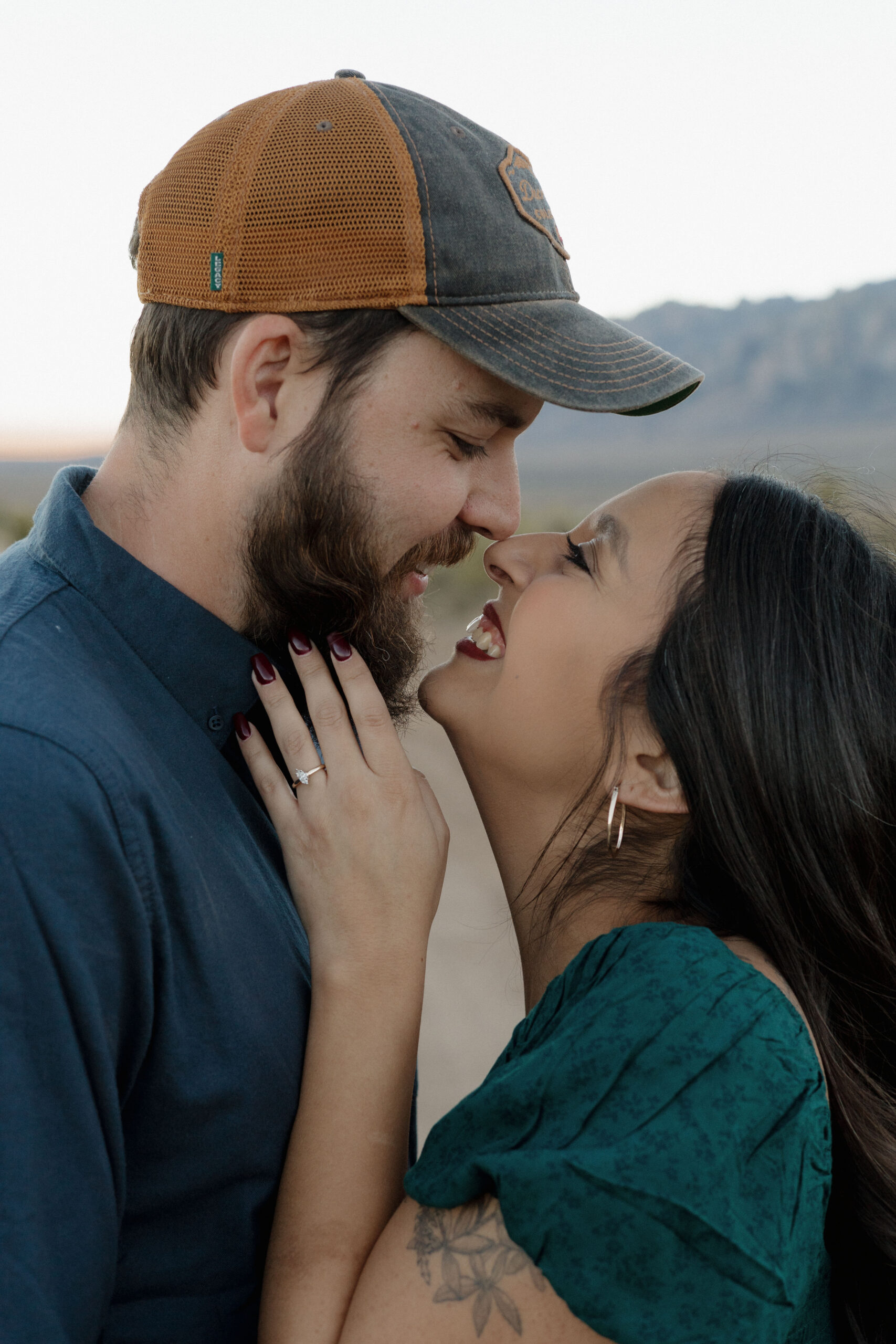 beautiful couple pose together during their desert engagement photo session