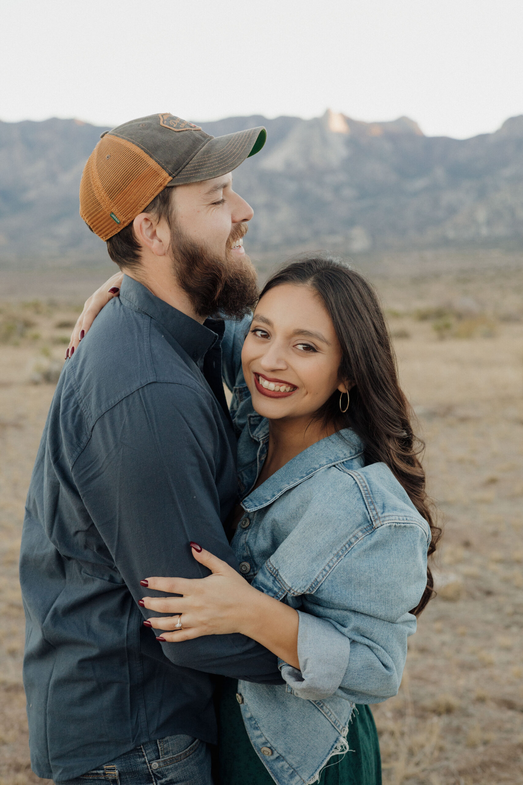 beautiful couple pose together during their desert engagement photo session