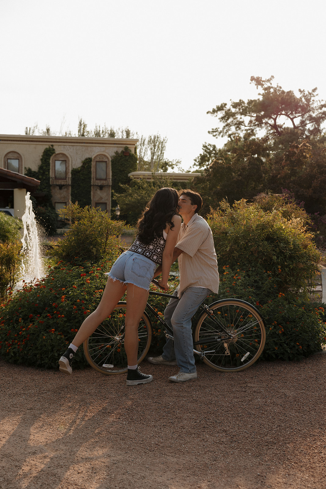 cute couples shoot posing with a bike